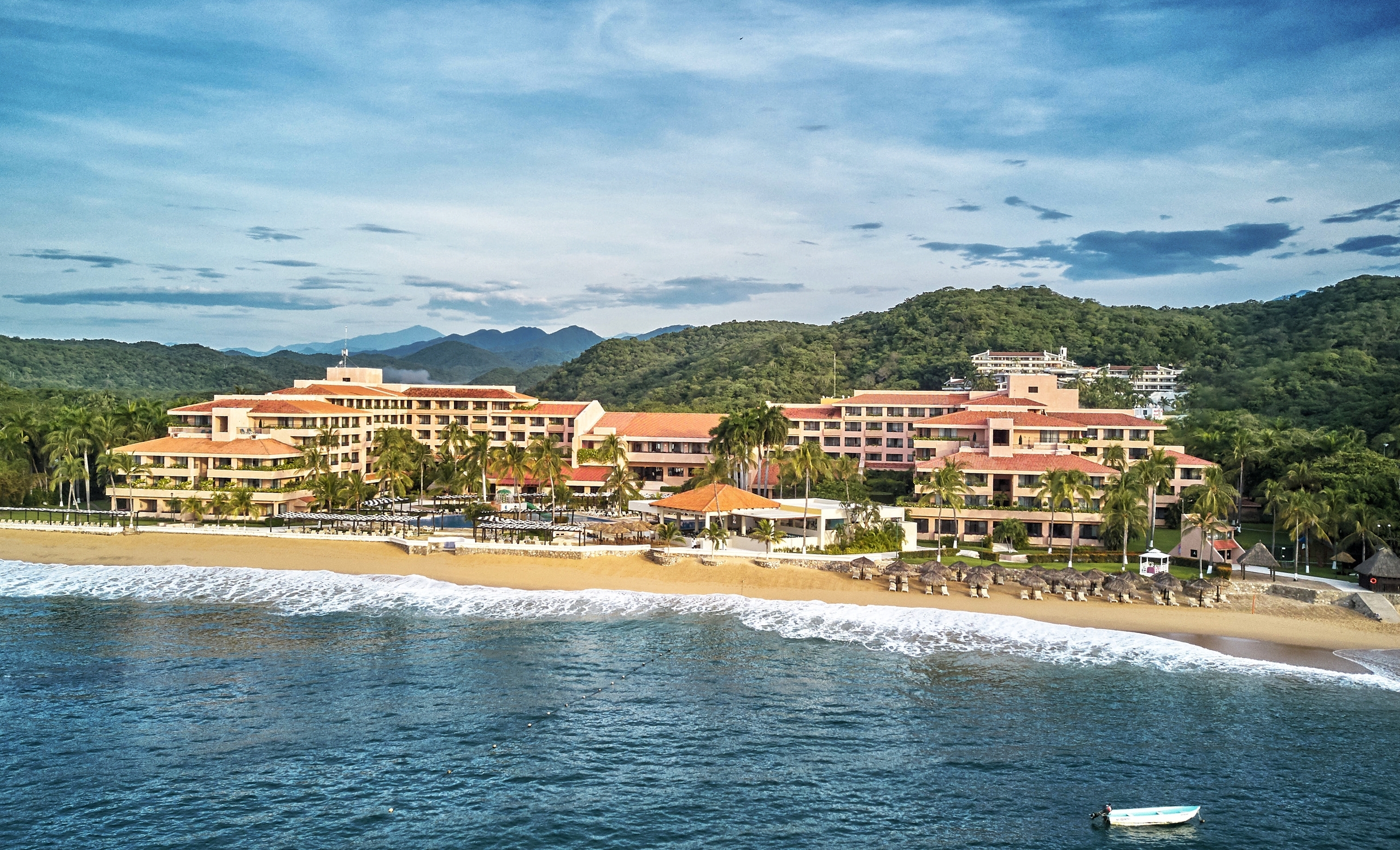 Barceló Huatulco Beach all-inclusive resort with beachfront pools, tropical gardens, and Pacific Ocean views on Oaxaca's coast.