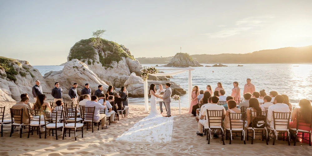 Beach by the Rocks wedding venue at Dreams Huatulco with dramatic rocky coastline backdrop