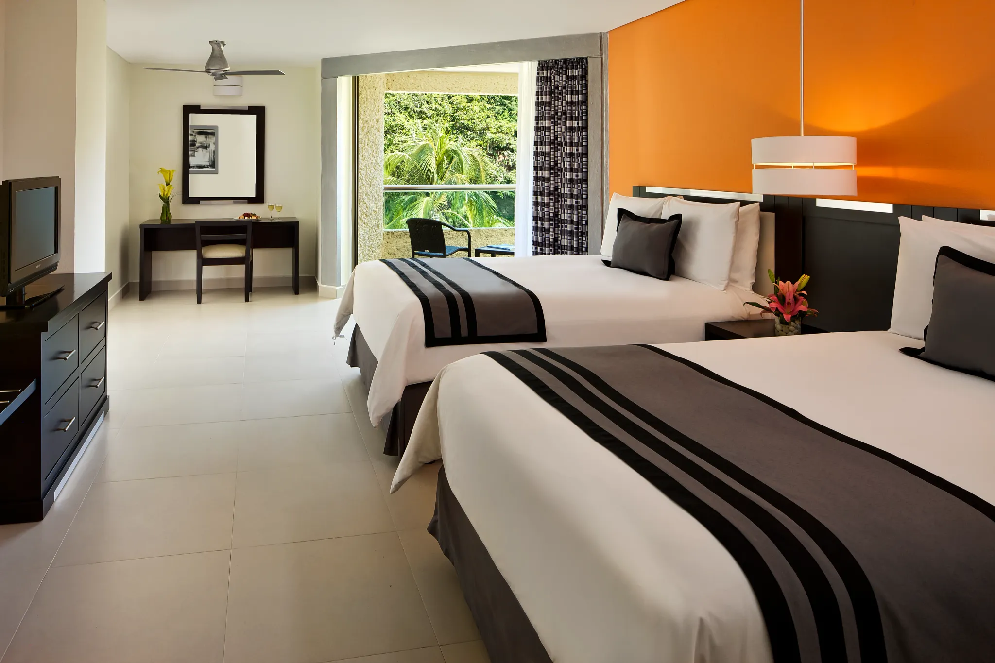 Deluxe Tropical View room with two double beds and private balcony at Dreams Huatulco Resort & Spa.