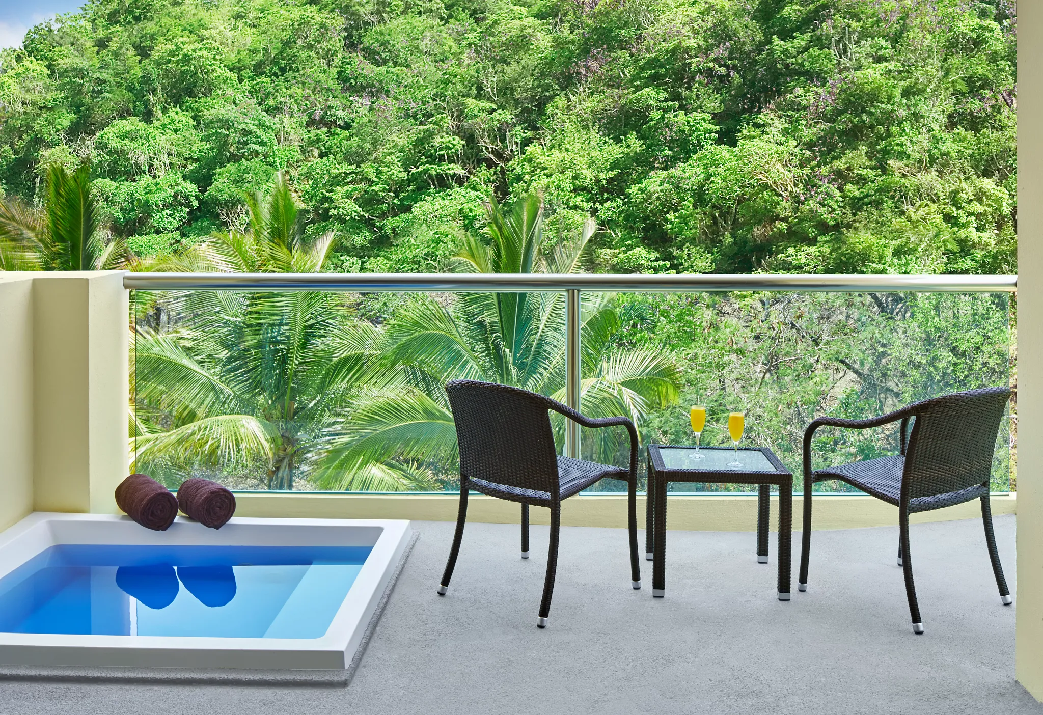 Private terrace with hot tub and tropical view at Deluxe Tropical View with Hot Tub room at Dreams Huatulco Resort & Spa.