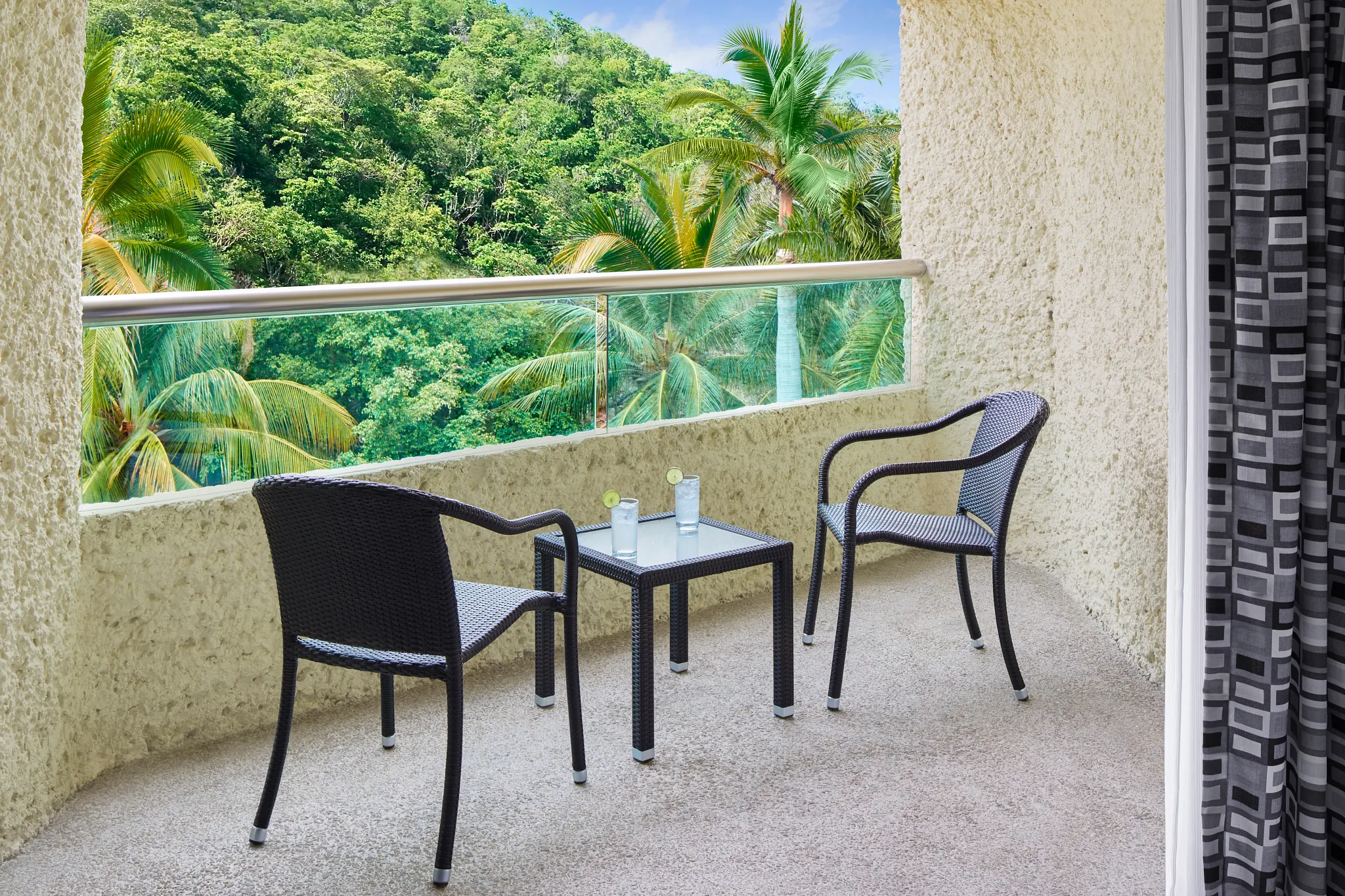 Private furnished terrace with tropical view at Deluxe Tropical View room at Dreams Huatulco Resort & Spa.
