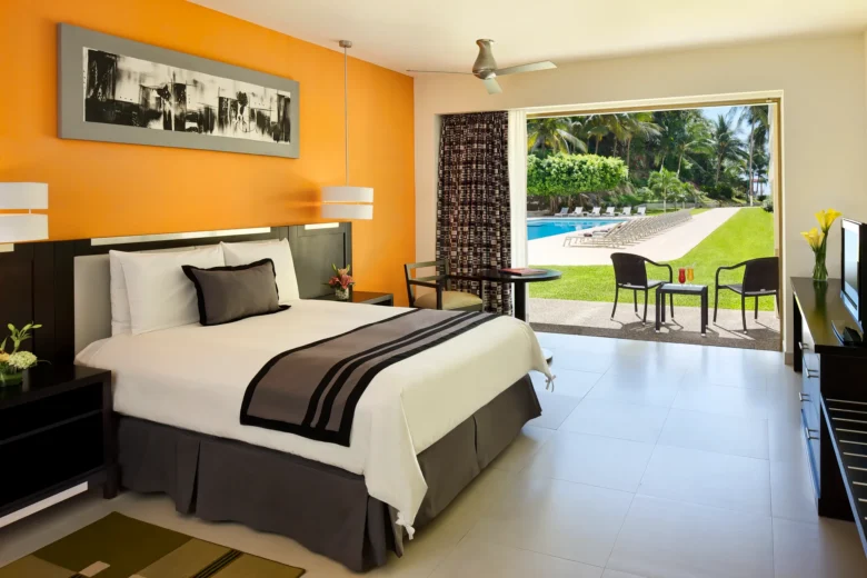 Deluxe Tropical View room with queen bed and modern décor at Dreams Huatulco Resort & Spa.