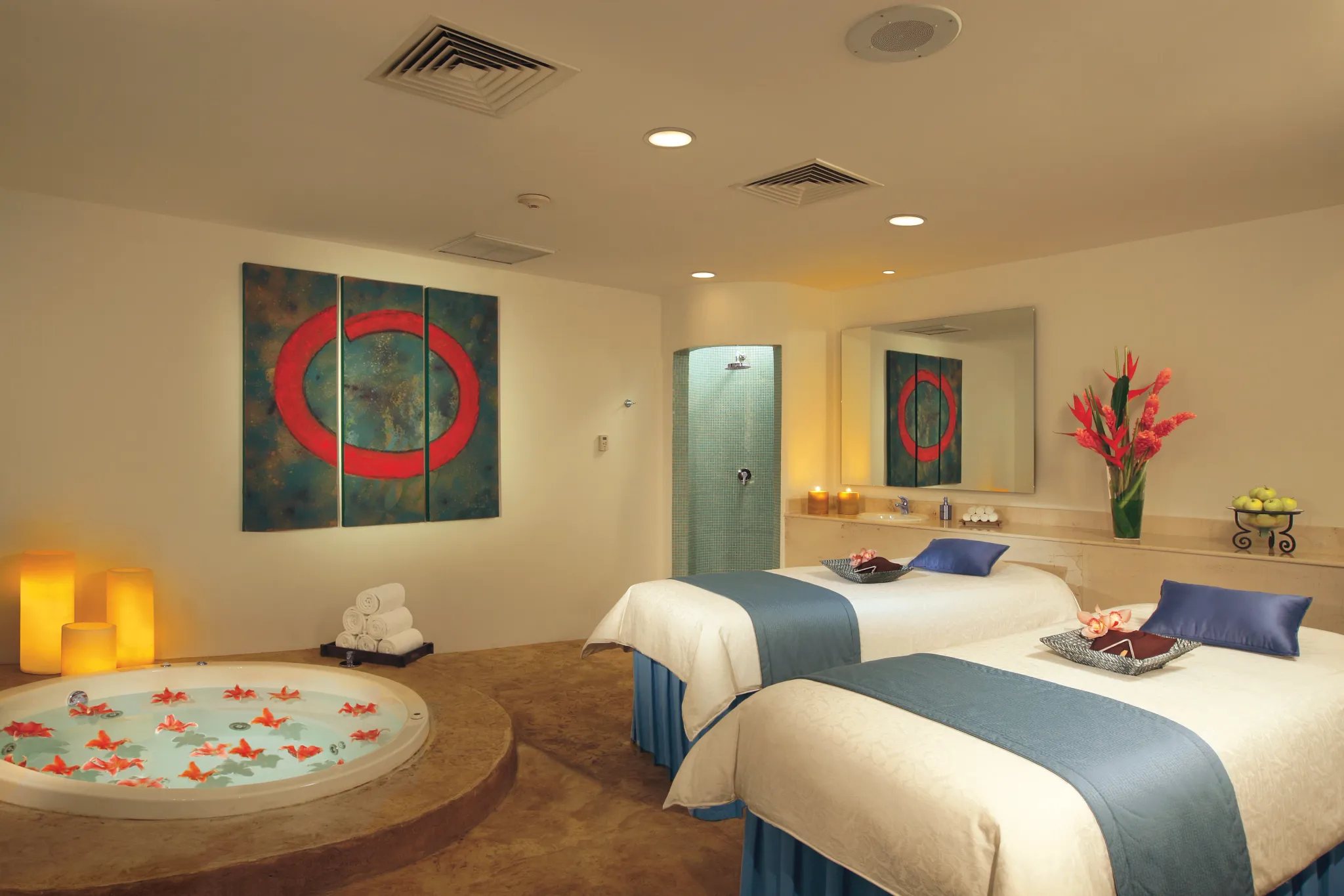 Couples enjoying a relaxing spa treatment in a private cabin at Dreams Huatulco Resort & Spa with whirlpool and massage beds.