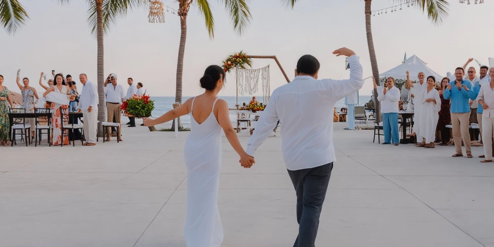 Couple celebrating their wedding reception on the Explanada Terrace at Dreams Huatulco Resort & Spa
