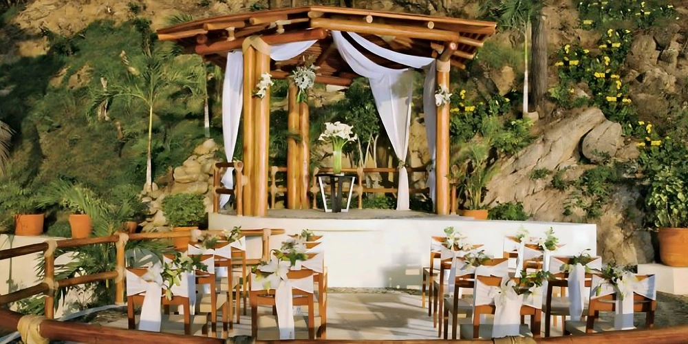 Garden gazebo wedding ceremony setup surrounded by lush greenery at Dreams Huatulco Resort & Spa