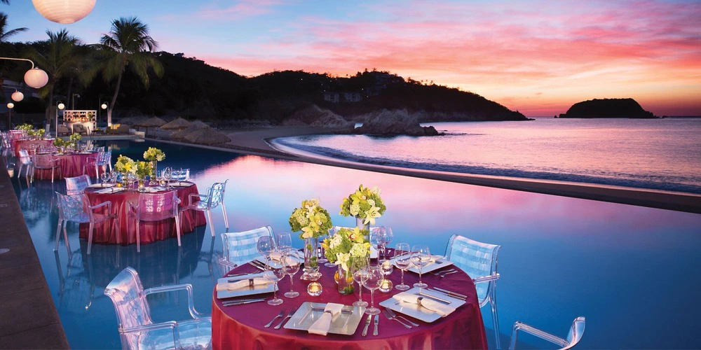 Himitsu Terrace wedding reception setup overlooking the infinity pool and ocean at sunset at Dreams Huatulco Resort & Spa