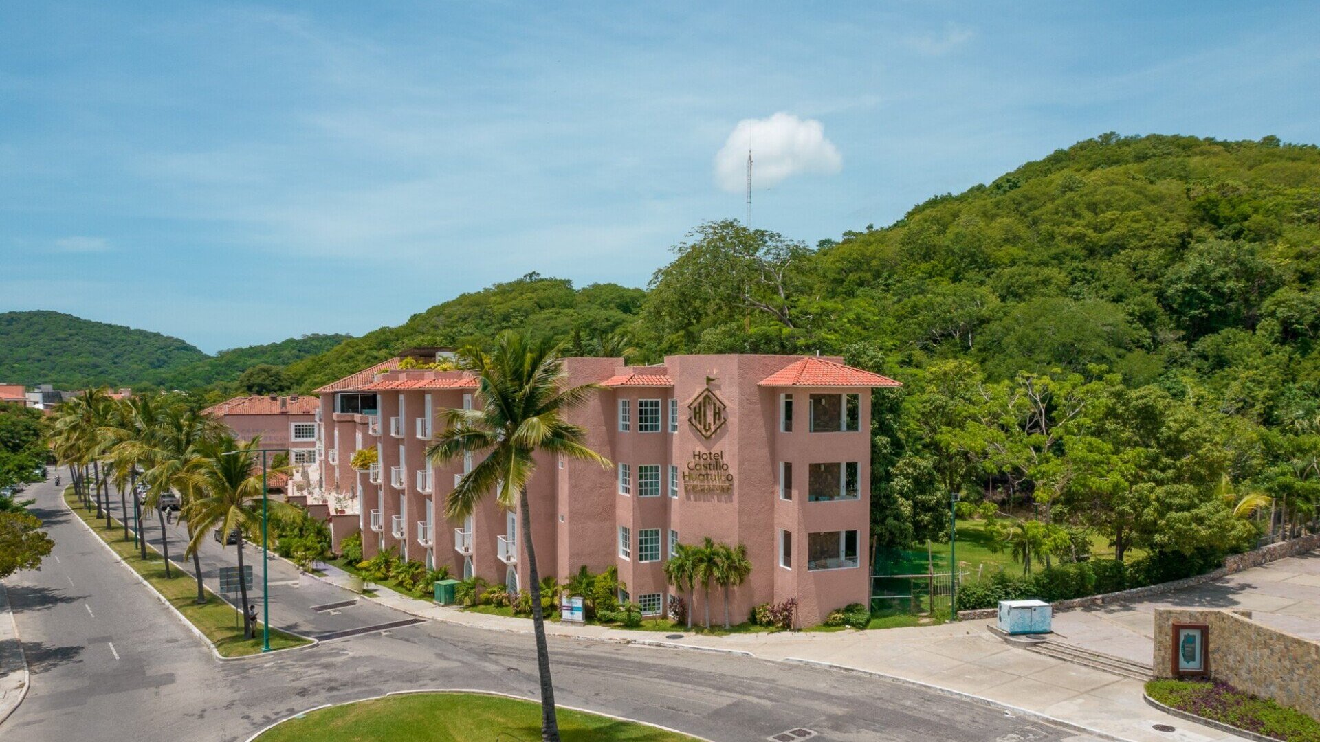 Hotel Castillo Huatulco & Beach Club exterior view showing the boutique property with pool area and ocean views in Huatulco, Mexico.