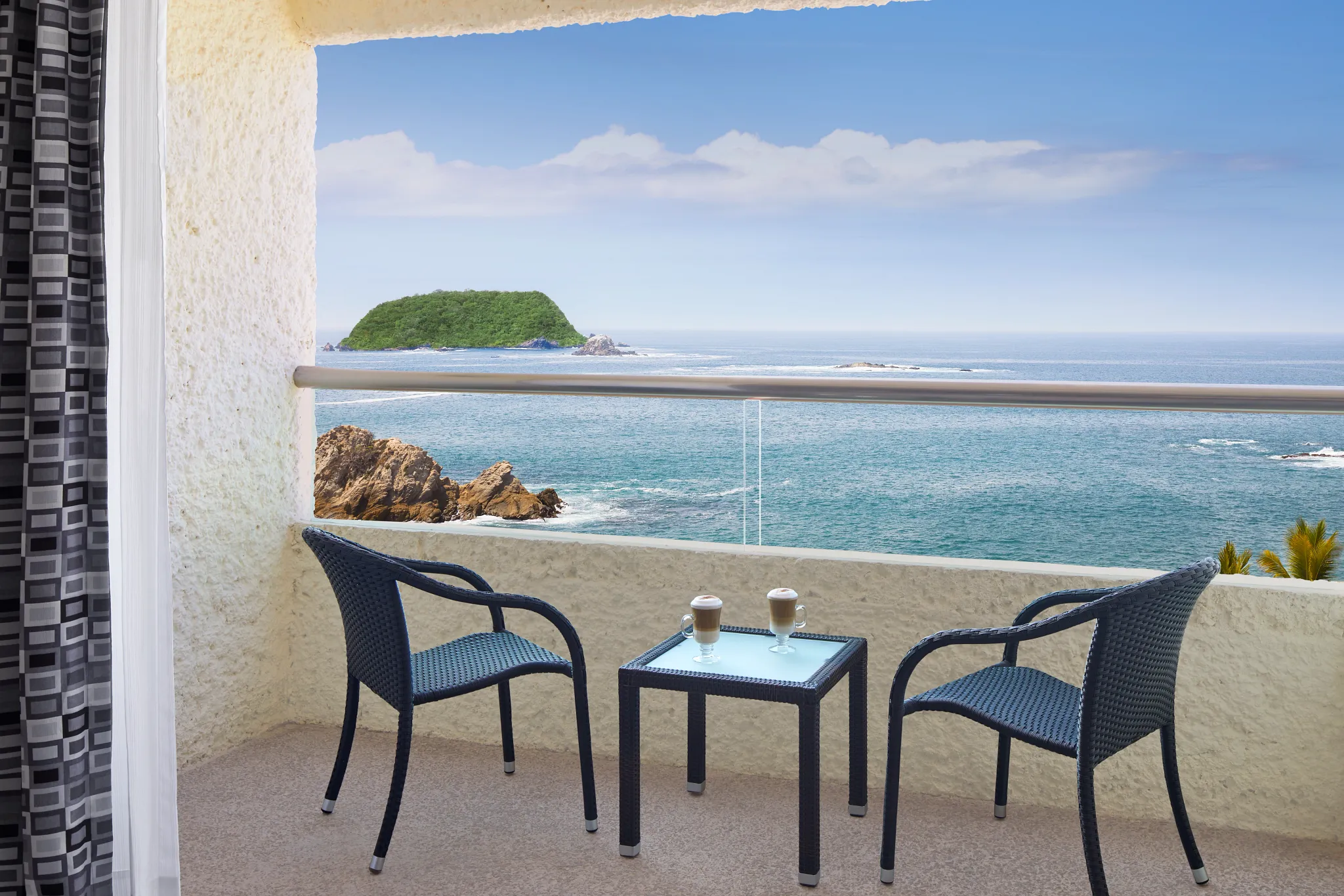 Private furnished balcony with oceanfront view at Preferred Club Deluxe Ocean Front room at Dreams Huatulco Resort & Spa.