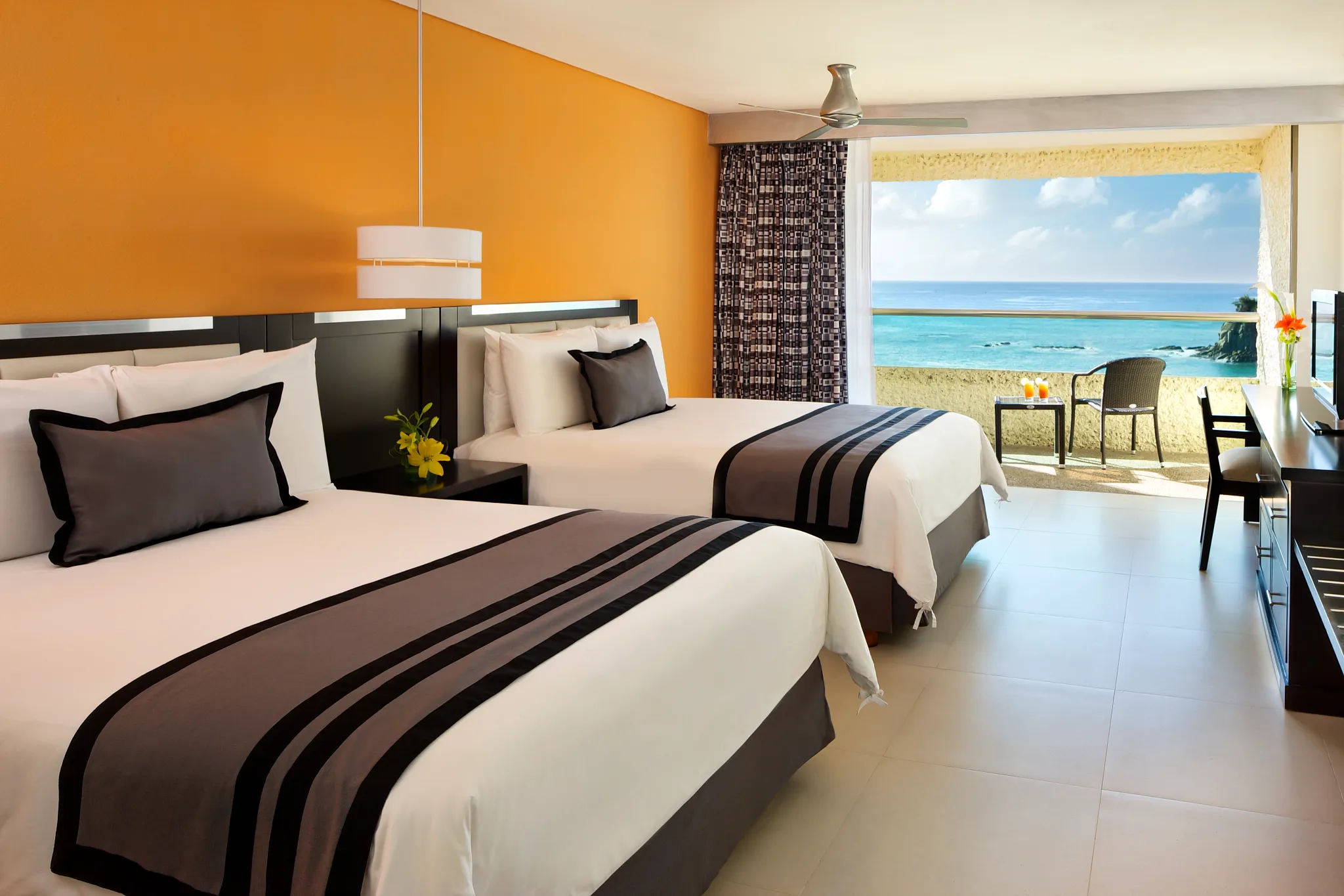 Preferred Club Deluxe Ocean Front room with two double beds at Dreams Huatulco Resort & Spa overlooking the Pacific Ocean.