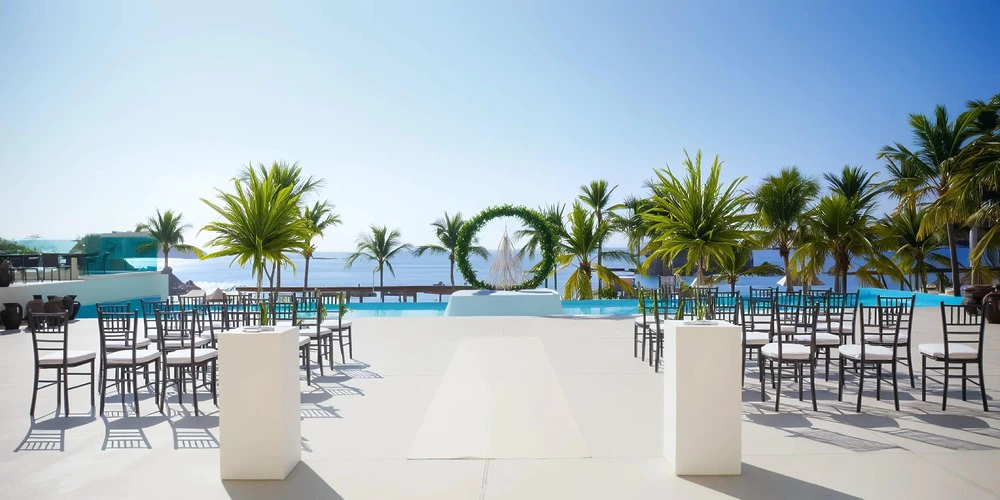 Rendezvous Terrace wedding ceremony setup with ocean and palm views at Dreams Huatulco Resort & Spa